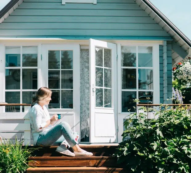 Drinking tea outside home on porch